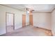 Comfortable bedroom featuring neutral carpeting, ceiling fan, and two closet doors at 4408 Robins Nest Rd, Concord, NC 28027