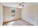 This bedroom features a ceiling fan and a window overlooking the backyard at 4408 Robins Nest Rd, Concord, NC 28027