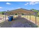 Carport with a gravel driveway and a shed in the background under a sunny sky at 4408 Robins Nest Rd, Concord, NC 28027