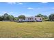 Exterior of single-story home with manicured lawn, flagpole, carport, and fencing under a clear sky at 4408 Robins Nest Rd, Concord, NC 28027