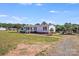 Exterior view of a single-story home with a well-manicured lawn, carport and American flag at 4408 Robins Nest Rd, Concord, NC 28027