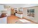 Bright kitchen with red countertops, stainless steel appliances, and wood-look flooring at 4408 Robins Nest Rd, Concord, NC 28027