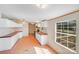 Bright kitchen with white cabinets, red countertops, and plenty of natural light from the window at 4408 Robins Nest Rd, Concord, NC 28027