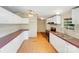 Well-equipped kitchen featuring white cabinets, stainless steel appliances, and laminate flooring at 4408 Robins Nest Rd, Concord, NC 28027