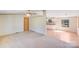 Spacious living room featuring neutral carpet and a doorway view of the kitchen and dining area at 4408 Robins Nest Rd, Concord, NC 28027