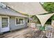 Spacious wooden deck with shade and access to the house and backyard at 6412 Old Meadow Rd # 69, Charlotte, NC 28227