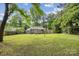 Expansive backyard with a well-maintained lawn, privacy fence, and a charming back porch with partial covering at 6412 Old Meadow Rd # 69, Charlotte, NC 28227