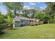 Expansive backyard with a deck, lush greenery, and plenty of space at 6412 Old Meadow Rd # 69, Charlotte, NC 28227