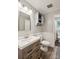 Bathroom featuring modern vanity, wood-look flooring, and decor shelves, combining style and functionality at 6412 Old Meadow Rd # 69, Charlotte, NC 28227