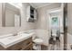 Bathroom featuring modern vanity, wood-look flooring, and decor shelves, combining style and functionality at 6412 Old Meadow Rd # 69, Charlotte, NC 28227
