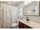 Updated bathroom with a decorative mirror and a floral shower curtain at 6412 Old Meadow Rd # 69, Charlotte, NC 28227