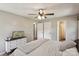 Comfortable bedroom featuring a ceiling fan, neutral tones, and an adjoining bathroom for convenience at 6412 Old Meadow Rd # 69, Charlotte, NC 28227