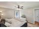 Bright bedroom featuring a ceiling fan, neutral tones, and a dresser with space for personal touches at 6412 Old Meadow Rd # 69, Charlotte, NC 28227