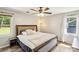 Serene bedroom with a ceiling fan, neutral tones, and ample natural light for a relaxing atmosphere at 6412 Old Meadow Rd # 69, Charlotte, NC 28227