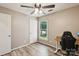 Bright bedroom featuring modern light fixture, closet, and wood floors at 6412 Old Meadow Rd # 69, Charlotte, NC 28227