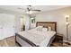 Comfortable bedroom with a ceiling fan, neutral tones, and ample natural light for a relaxing atmosphere at 6412 Old Meadow Rd # 69, Charlotte, NC 28227