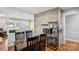 Cozy dining area with wood accent wall, open to the kitchen and living spaces at 6412 Old Meadow Rd # 69, Charlotte, NC 28227