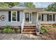 Inviting front entrance with brick steps, a white railing, and a glass front door at 6412 Old Meadow Rd # 69, Charlotte, NC 28227
