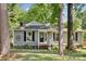 Single-story home with gray siding, black shutters, and a front yard with mature trees at 6412 Old Meadow Rd # 69, Charlotte, NC 28227