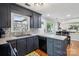 Cozy kitchen featuring an eat-in bar, dark cabinetry, and stainless steel dishwasher at 6412 Old Meadow Rd # 69, Charlotte, NC 28227