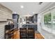 Bright kitchen and dining area with modern fixtures, wood floors, and stainless appliances at 6412 Old Meadow Rd # 69, Charlotte, NC 28227