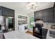 Bright kitchen featuring stainless steel appliances, dark cabinets, and an adjacent laundry area at 6412 Old Meadow Rd # 69, Charlotte, NC 28227