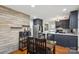 Open floor plan showing the kitchen and dining area with modern appliances and finishes at 6412 Old Meadow Rd # 69, Charlotte, NC 28227