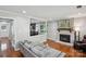 Inviting living room with fireplace, TV, comfortable seating, and open view to the kitchen at 6412 Old Meadow Rd # 69, Charlotte, NC 28227