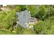 Aerial view of a charming home surrounded by mature trees and featuring an enclosed sunroom at 6914 Riesman Ln # 95, Charlotte, NC 28210