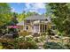 Expansive backyard featuring a patio, screened porch, balcony, lush landscaping, and mature trees at 6914 Riesman Ln # 95, Charlotte, NC 28210
