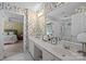 Stylish double sink bathroom with bright lighting and a view into the bedroom at 6914 Riesman Ln # 95, Charlotte, NC 28210