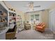 Bright room with book shelves and comfortable furniture next to a window with natural lighting at 6914 Riesman Ln # 95, Charlotte, NC 28210