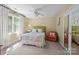 Bright bedroom with a queen bed, soft carpeting, and ample natural light from a large window at 6914 Riesman Ln # 95, Charlotte, NC 28210