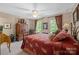 Relaxing bedroom with a cozy quilt on the bed, complemented by natural light and a ceiling fan at 6914 Riesman Ln # 95, Charlotte, NC 28210