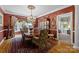 Formal dining room featuring hardwood floors, red wall paper, a chandelier and a large window at 6914 Riesman Ln # 95, Charlotte, NC 28210