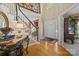 Grand foyer features hardwood floors, staircase, and detailed trim, showcasing an inviting entrance at 6914 Riesman Ln # 95, Charlotte, NC 28210