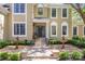 Close up view of the home's entrance, showcasing the front door, fountains, manicured landscape and walkway at 6914 Riesman Ln # 95, Charlotte, NC 28210