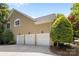 Three-car garage showcasing ample parking space with traditional doors and exterior lighting at 6914 Riesman Ln # 95, Charlotte, NC 28210