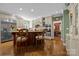 Bright kitchen featuring a wood island, stainless steel fridge, double ovens, and view into a formal dining room at 6914 Riesman Ln # 95, Charlotte, NC 28210