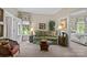Cozy living room with a comfortable sofa, decorative lamps, and views into the bedroom at 6914 Riesman Ln # 95, Charlotte, NC 28210