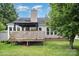 Charming backyard with a wooden deck and lush green lawn, perfect for outdoor entertaining at 7106 Kinsmore Ln, Charlotte, NC 28269