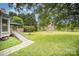 Expansive backyard featuring a patio, lush greenery, and a classic fence surrounding the property at 7106 Kinsmore Ln, Charlotte, NC 28269