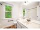 Bright bathroom with a large mirror, updated fixtures, and a window offering a view at 7106 Kinsmore Ln, Charlotte, NC 28269