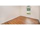 Well lit bedroom featuring hardwood floors and a large window for natural light at 7106 Kinsmore Ln, Charlotte, NC 28269