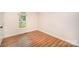Bedroom featuring hardwood floors and a bright window overlooking the yard at 7106 Kinsmore Ln, Charlotte, NC 28269