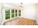 Light-filled dining area featuring laminate flooring, ample windows overlooking the yard, and elegant trimwork, ideal for entertaining guests at 7106 Kinsmore Ln, Charlotte, NC 28269