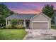Charming single-story home with a well-manicured lawn and attached two-car garage at 7106 Kinsmore Ln, Charlotte, NC 28269