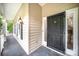Close-up of a front porch featuring a secure black metal door, warm exterior lighting, and a freshly painted surface at 7106 Kinsmore Ln, Charlotte, NC 28269