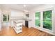 Open kitchen with a view to the backyard with white cabinets and granite countertops at 7106 Kinsmore Ln, Charlotte, NC 28269
