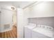 Bright laundry room with washer, dryer, and doorway leading to adjacent bathroom at 7106 Kinsmore Ln, Charlotte, NC 28269